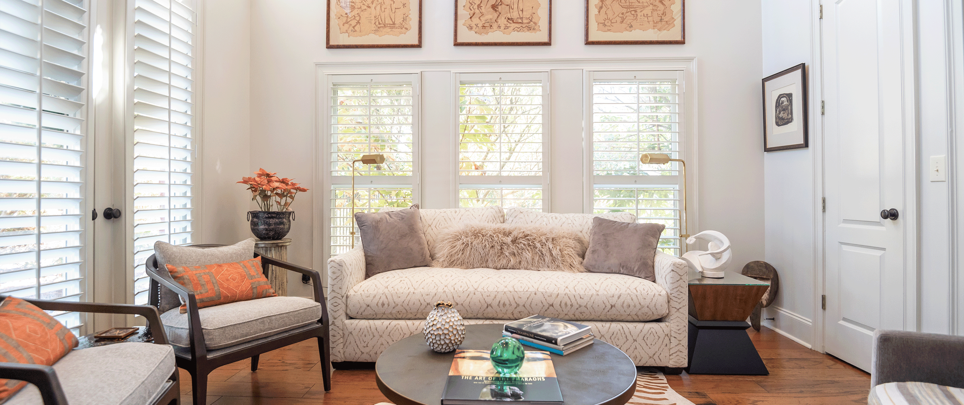 A stunning living room complete with moveable louvered shutters and doors built and installed by Dwell Shutter and Blinds.