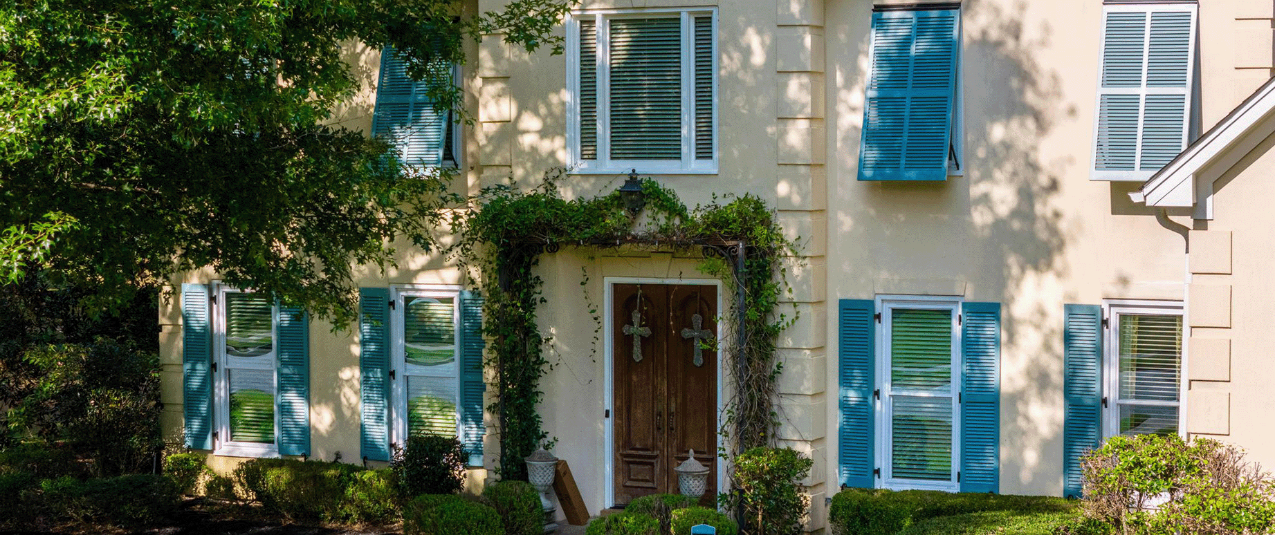 Bright colored exterior shutters built and installed by Dwell Shutter and Blinds.