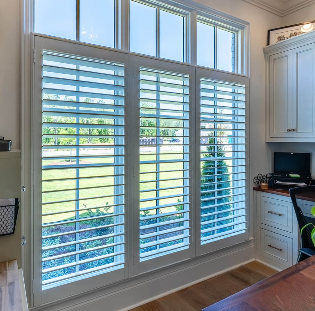 Moveable Louvered interior shutters installed in a home office. Built and installed by Dwell Shutter and Blinds