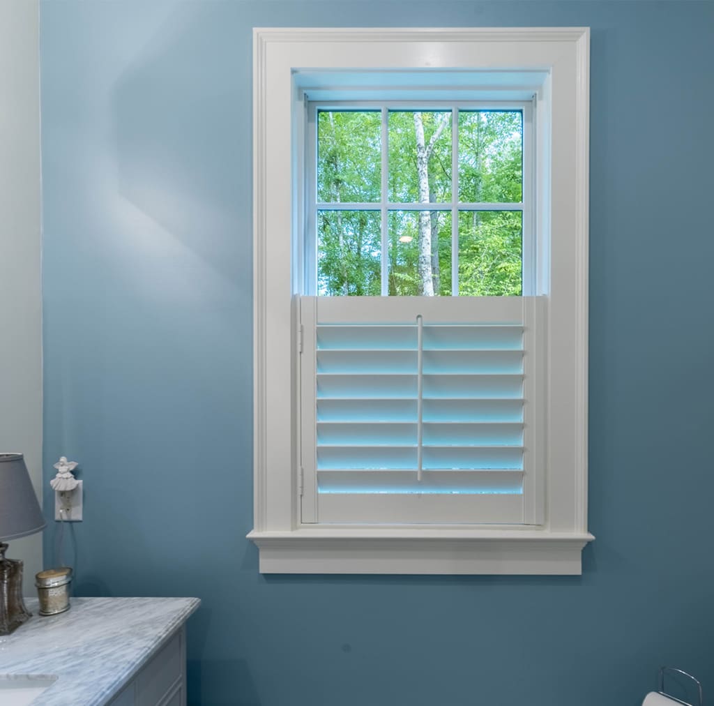 A small half-window sized moveable louvered shutters built in a bathroom. Built and installed by Dwell Shutter and Blinds.
